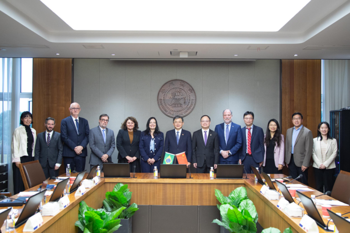 A group of people standing in a room

Description automatically generated